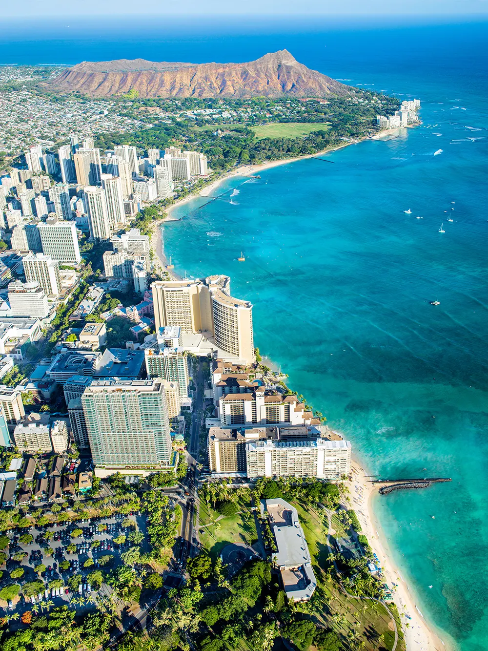 Aerial view of Waikiki Beach and coastline with Diamond Head in the distance.